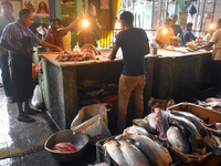 Vendors prepare fish inside a wholesale market in Kolkata, India, on November 24, 2024. (