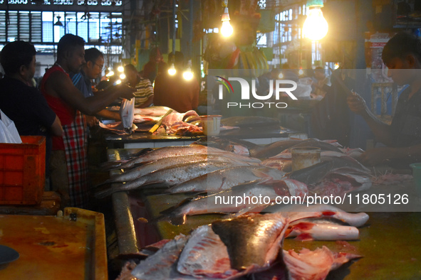 Vendors prepare fish inside a wholesale market in Kolkata, India, on November 24, 2024. 