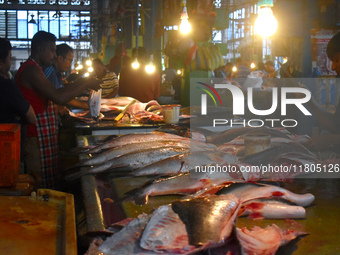 Vendors prepare fish inside a wholesale market in Kolkata, India, on November 24, 2024. (