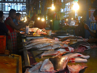 Vendors prepare fish inside a wholesale market in Kolkata, India, on November 24, 2024. (