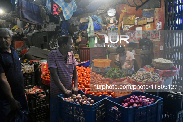 Vendors sell vegetables inside a wholesale market in Kolkata, India, on November 24, 2024. 