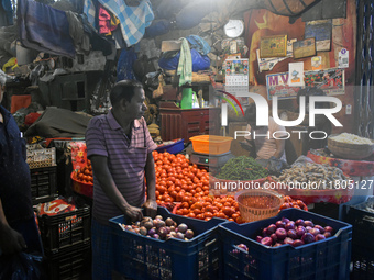 Vendors sell vegetables inside a wholesale market in Kolkata, India, on November 24, 2024. (