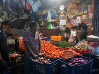 Vendors sell vegetables inside a wholesale market in Kolkata, India, on November 24, 2024. (