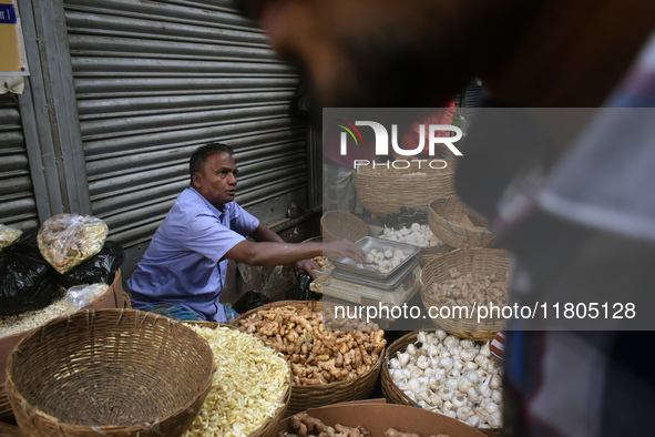 A vendor sells ginger and garlic inside a wholesale market in Kolkata, India, on November 24, 2024. 