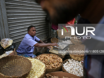 A vendor sells ginger and garlic inside a wholesale market in Kolkata, India, on November 24, 2024. (