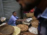 A vendor sells ginger and garlic inside a wholesale market in Kolkata, India, on November 24, 2024. (