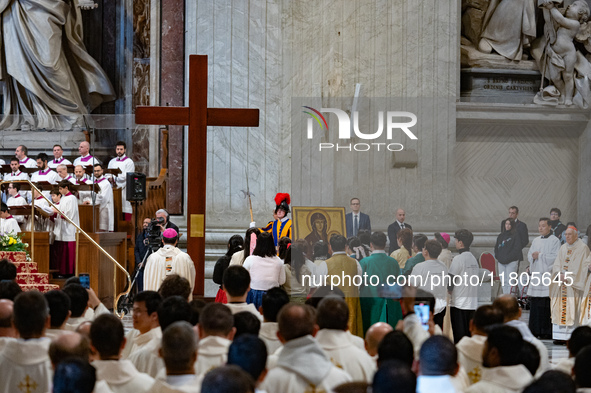 Youths hand over the cross of the World Youth Day to organizers of the next edition that will be held in Seoul, South Korea, in 2027, during...