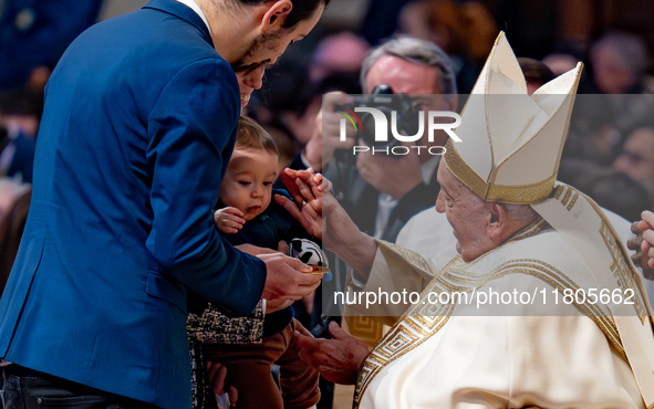 Pope Francis greets a newborn during the Holy Mass on World Youth Day on November 24, 2024. 