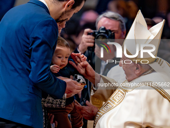 Pope Francis greets a newborn during the Holy Mass on World Youth Day on November 24, 2024. (