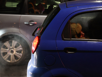 A person rests in a car in Torun, Poland on November 23, 2024. (