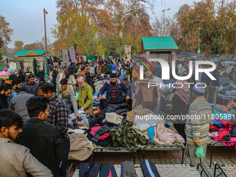 People buy warm clothes at a Sunday Market in Srinagar, Jammu and Kashmir, on November 24, 2024. (