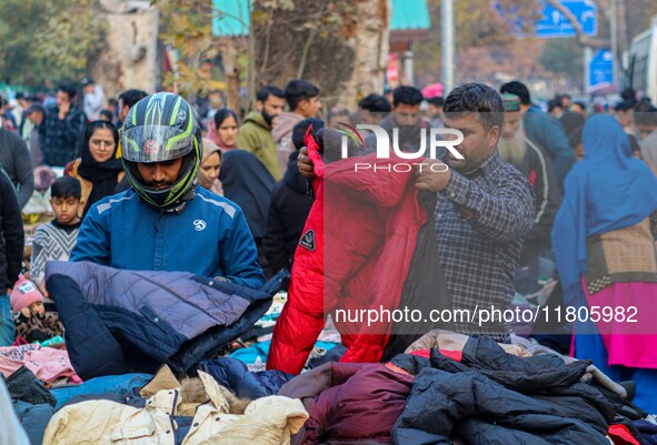 People buy warm clothes at a Sunday Market in Srinagar, Jammu and Kashmir, on November 24, 2024. 