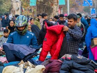 People buy warm clothes at a Sunday Market in Srinagar, Jammu and Kashmir, on November 24, 2024. (