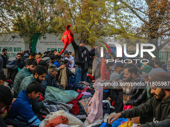 People buy warm clothes at a Sunday Market in Srinagar, Jammu and Kashmir, on November 24, 2024. (