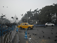 A yellow taxi moves on the road on a smoggy morning due to air pollution in Kolkata, India, on November 24, 2024. (