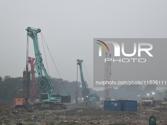 People work on a metro construction site on a smoggy morning due to air pollution in Kolkata, India, on November 24, 2024. (