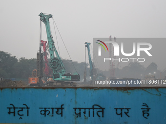 People work on a metro construction site on a smoggy morning due to air pollution in Kolkata, India, on November 24, 2024. (