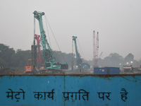 People work on a metro construction site on a smoggy morning due to air pollution in Kolkata, India, on November 24, 2024. (