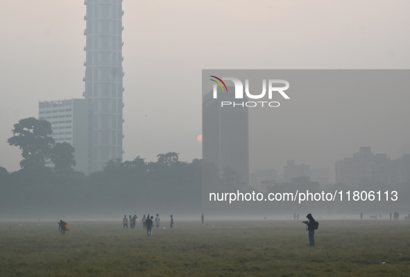 People play inside the ground on a smoggy morning due to air pollution in Kolkata, India, on November 24, 2024. 