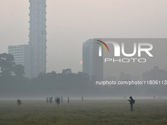 People play inside the ground on a smoggy morning due to air pollution in Kolkata, India, on November 24, 2024. (