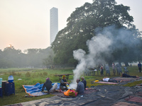 People burn fires, causing smoke on a smoggy morning in Kolkata, India, on November 24, 2024. (