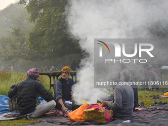 People burn fires, causing smoke on a smoggy morning in Kolkata, India, on November 24, 2024. (