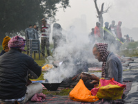 People burn fires, causing smoke on a smoggy morning in Kolkata, India, on November 24, 2024. (