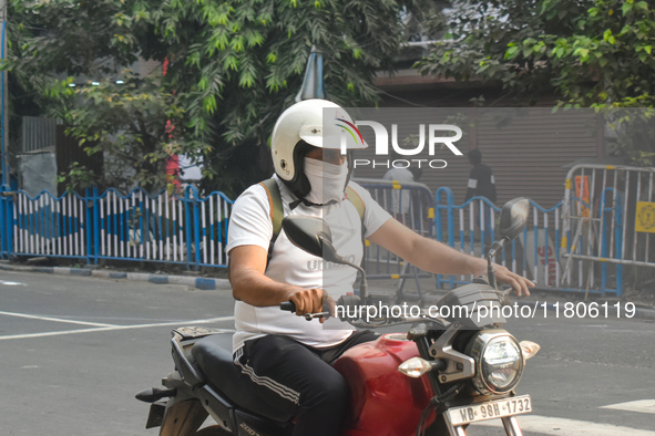 A person rides a bike on a smoggy morning due to air pollution in Kolkata, India, on November 24, 2024. 