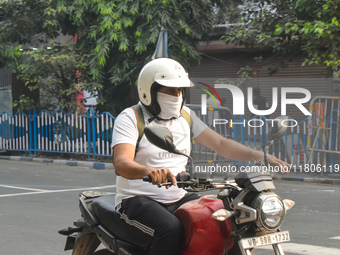 A person rides a bike on a smoggy morning due to air pollution in Kolkata, India, on November 24, 2024. (