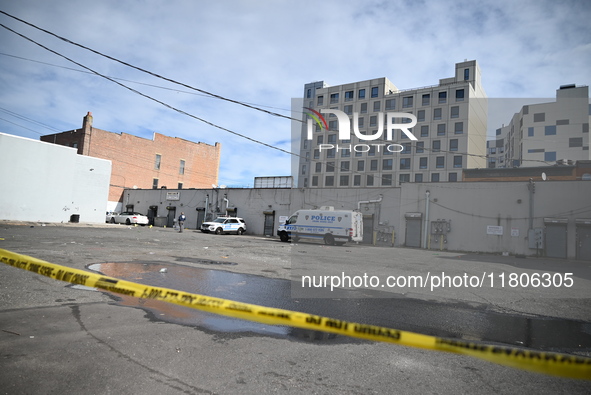 Evidence markers highlight where shell casings and other evidence are discovered by a white vehicle where a 35-year-old man is killed after...