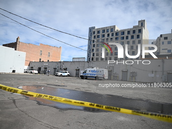 Evidence markers highlight where shell casings and other evidence are discovered by a white vehicle where a 35-year-old man is killed after...