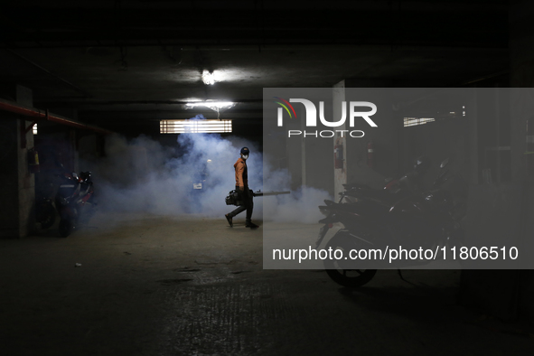 A man sprays insecticide to kill mosquitoes in Dhaka, Bangladesh, on November 24, 2024. At least eleven dengue patients die in the last 24 h...