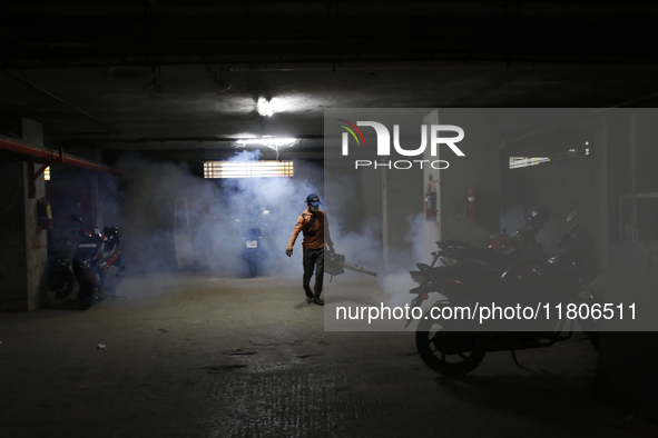 A man sprays insecticide to kill mosquitoes in Dhaka, Bangladesh, on November 24, 2024. At least eleven dengue patients die in the last 24 h...