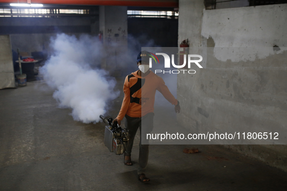 A man sprays insecticide to kill mosquitoes in Dhaka, Bangladesh, on November 24, 2024. At least eleven dengue patients die in the last 24 h...