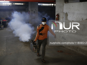 A man sprays insecticide to kill mosquitoes in Dhaka, Bangladesh, on November 24, 2024. At least eleven dengue patients die in the last 24 h...