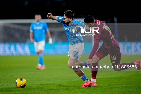 Khvicha Kvaratskhelia of SSC Napoli and Zeki Celik of AS Roma compete for the ball during the serie Serie A Enilive match between SSC Napoli...