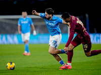 Khvicha Kvaratskhelia of SSC Napoli and Zeki Celik of AS Roma compete for the ball during the serie Serie A Enilive match between SSC Napoli...