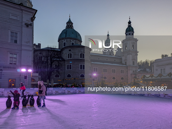 People enjoy the pre-Christmas atmosphere in the old town of Salzburg, Austria, on December 7, 2023. 