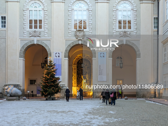 People enjoy the pre-Christmas atmosphere in the old town of Salzburg, Austria, on December 7, 2023. 