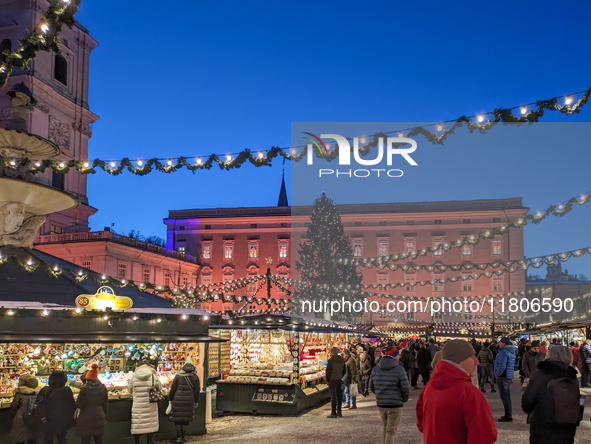 People enjoy the pre-Christmas atmosphere in the old town of Salzburg, Austria, on December 7, 2023. 