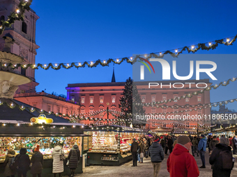 People enjoy the pre-Christmas atmosphere in the old town of Salzburg, Austria, on December 7, 2023. (