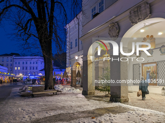 People enjoy the pre-Christmas atmosphere in the old town of Salzburg, Austria, on December 7, 2023. (