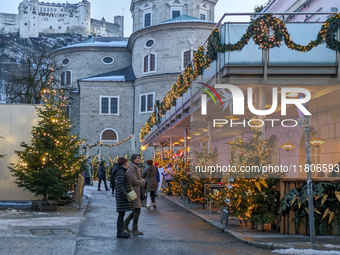 People enjoy the pre-Christmas atmosphere in the old town of Salzburg, Austria, on December 7, 2023. (