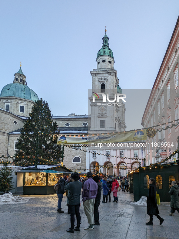 People enjoy the pre-Christmas atmosphere in the old town of Salzburg, Austria, on December 7, 2023. 