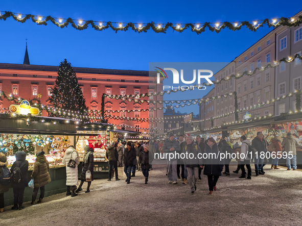 People enjoy the pre-Christmas atmosphere in the old town of Salzburg, Austria, on December 7, 2023. 