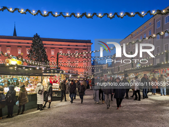 People enjoy the pre-Christmas atmosphere in the old town of Salzburg, Austria, on December 7, 2023. (