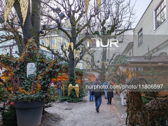 People enjoy the pre-Christmas atmosphere in the old town of Salzburg, Austria, on December 7, 2023. 