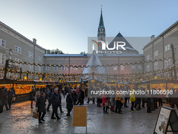 People enjoy the pre-Christmas atmosphere in the old town of Salzburg, Austria, on December 7, 2023. 