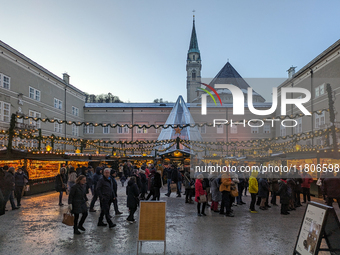 People enjoy the pre-Christmas atmosphere in the old town of Salzburg, Austria, on December 7, 2023. (