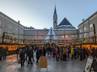 People enjoy the pre-Christmas atmosphere in the old town of Salzburg, Austria, on December 7, 2023. (